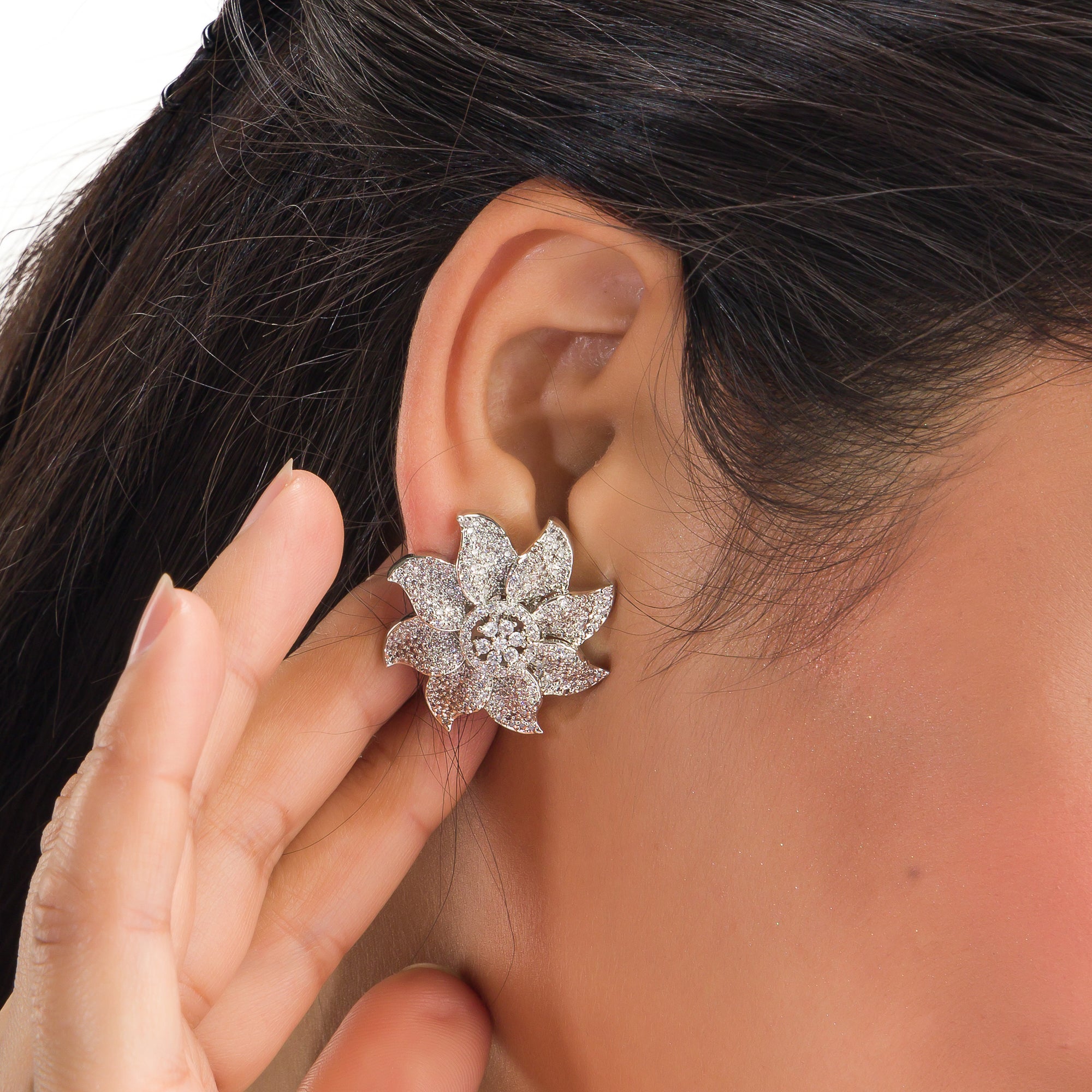 Flowery zircon stud earrings offer charming elegance with sparkling grace for a refined look.
