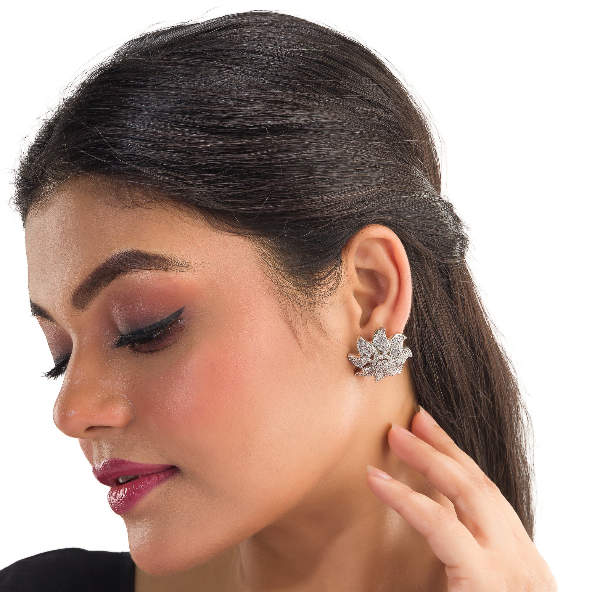 Flowery zircon stud earrings offer charming elegance with sparkling grace for a refined look.
