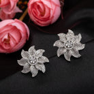 Flowery zircon stud earrings offer charming elegance with sparkling grace for a refined look.
