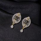  "Zircon earrings with a golden touch combine sparkling brilliance and a warm, luxurious finish."
