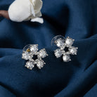 "Small flower-shaped zircon earrings offer subtle charm and elegant sparkle for a refined, timeless look."
