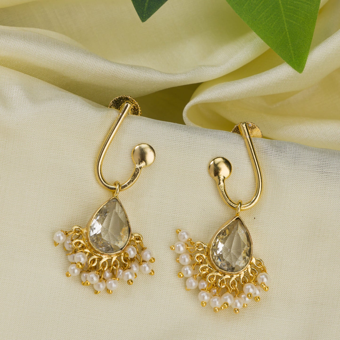 SMALL GOLD-TONE EARRINGS WITH WHITE PEARLS PROVIDE A DELICATE, REFINED TOUCH OF TIMELESS ELEGANCE.