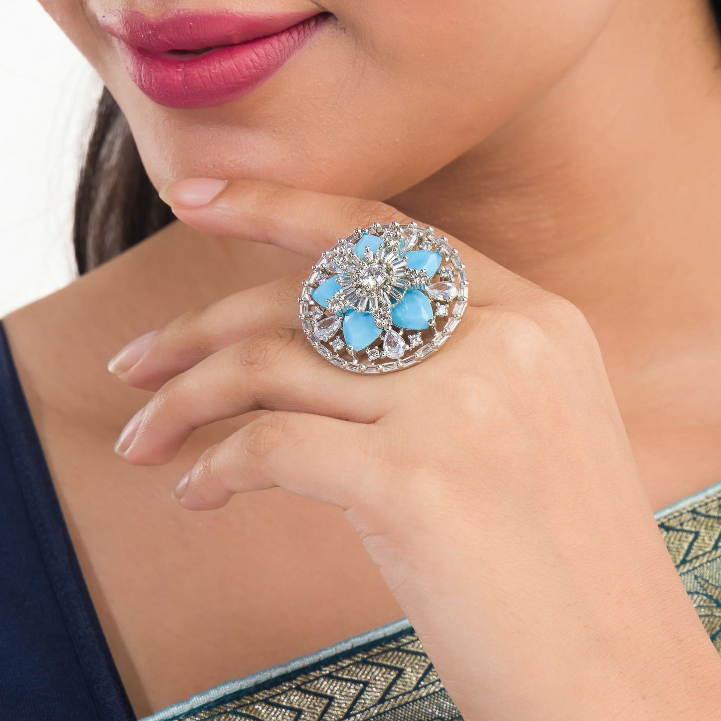 A SMALL AQUA ZIRCON FINGER RING OFFERS A SUBTLE YET ELEGANT TOUCH OF SERENE BLUE BRILLIANCE.