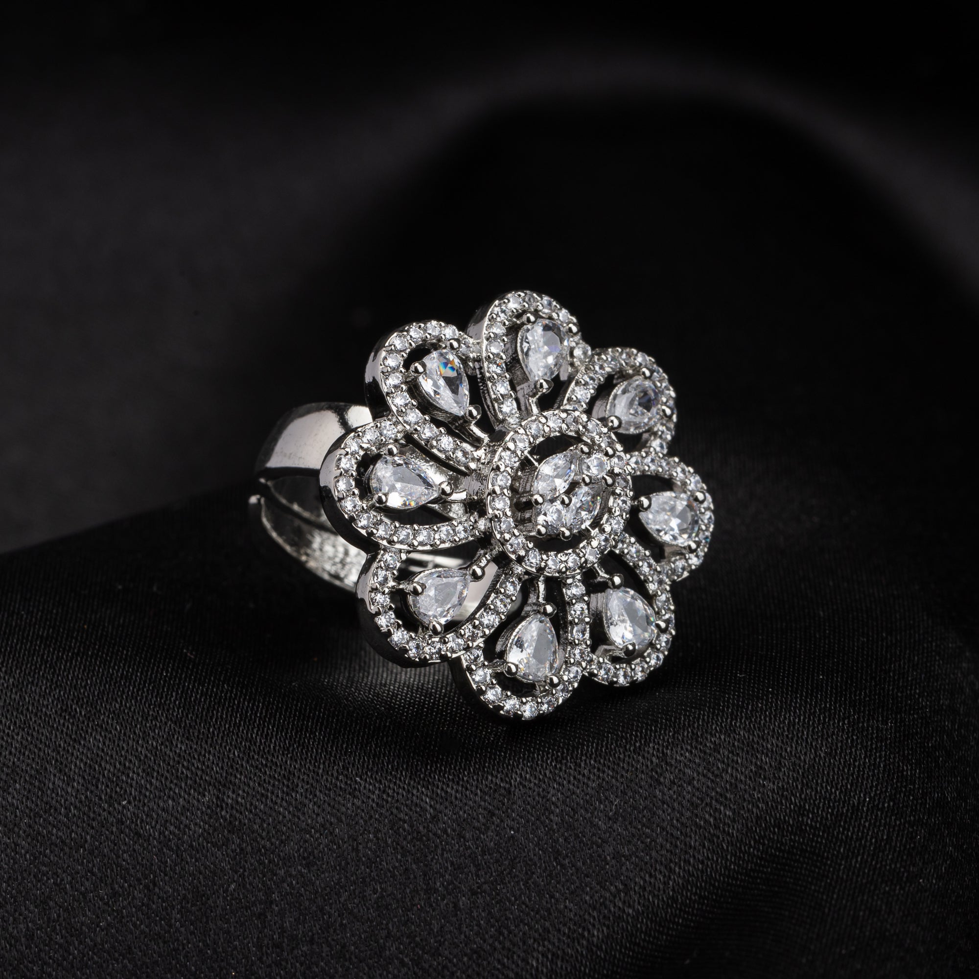 Silver floral zircon finger ring combines timeless beauty with sparkling brilliance.
