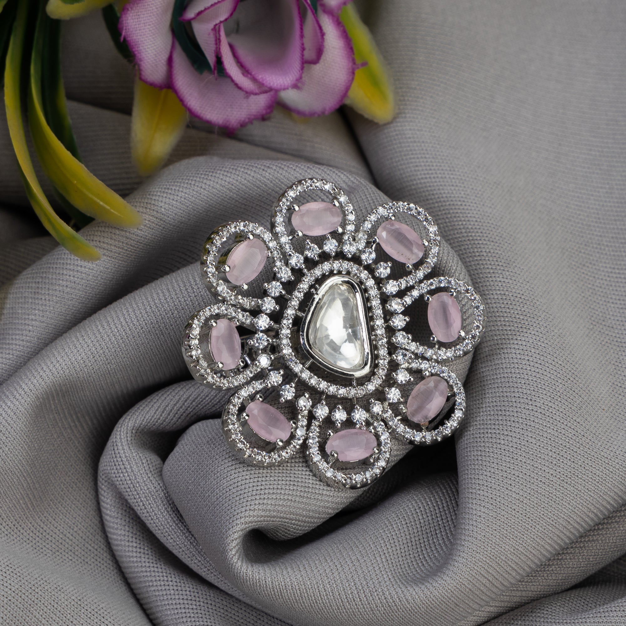 Floral zircon finger ring with orchid stones offers a graceful and elegant party look.
