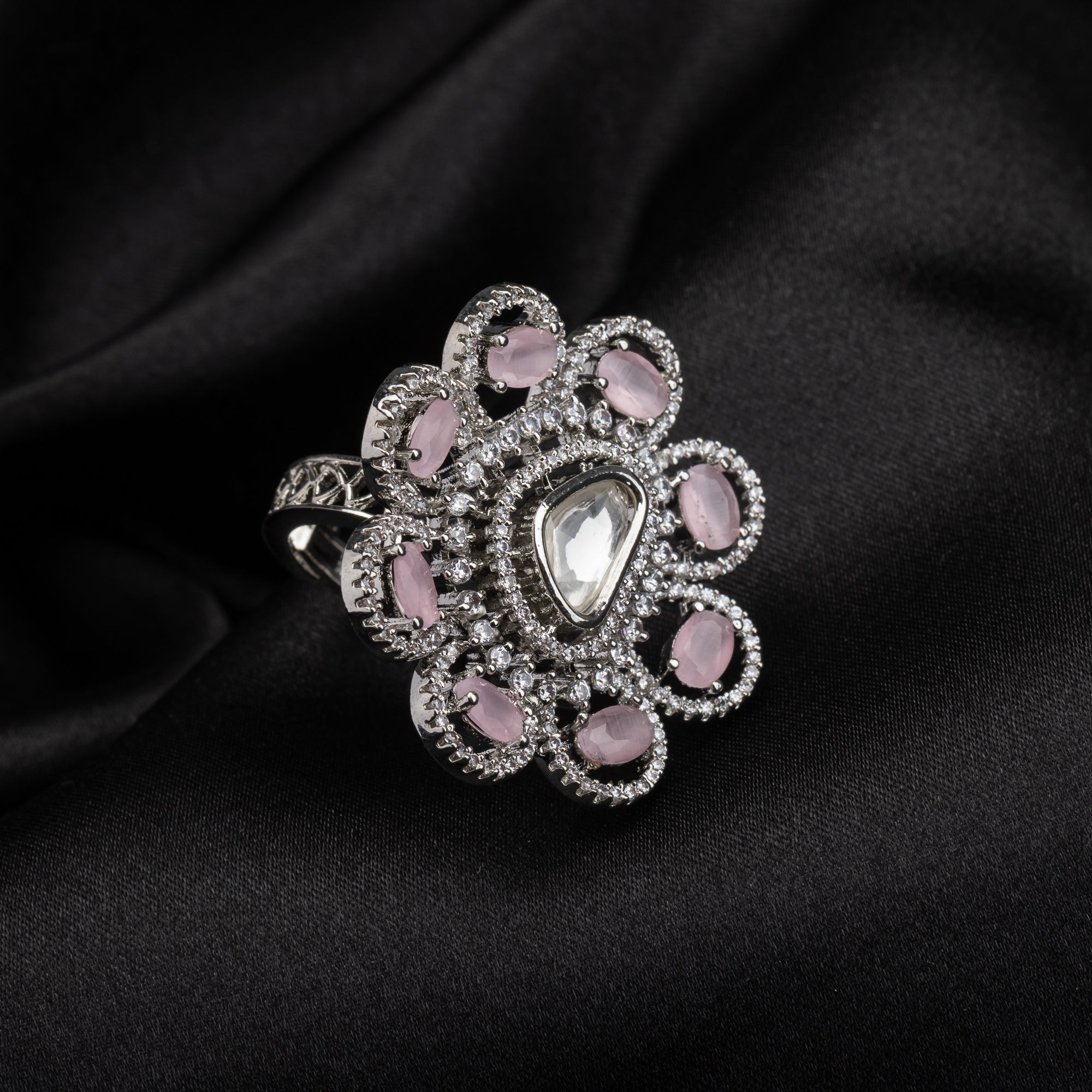 Floral zircon finger ring with orchid stones offers a graceful and elegant party look.
