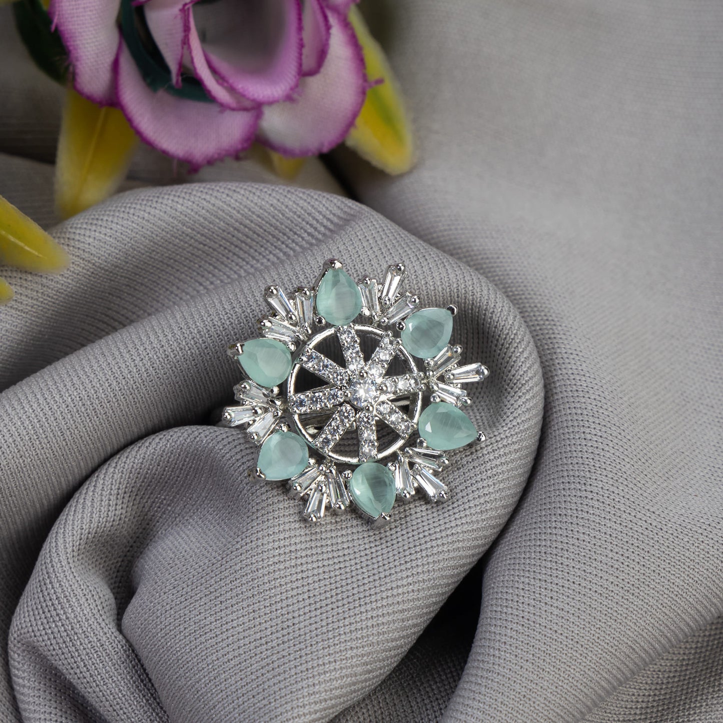 AQUA- COLOURED STONE STUDDED FLORAL DESIGN ZIRCON FINGER RING WITH AQUA- COLOURED STONE