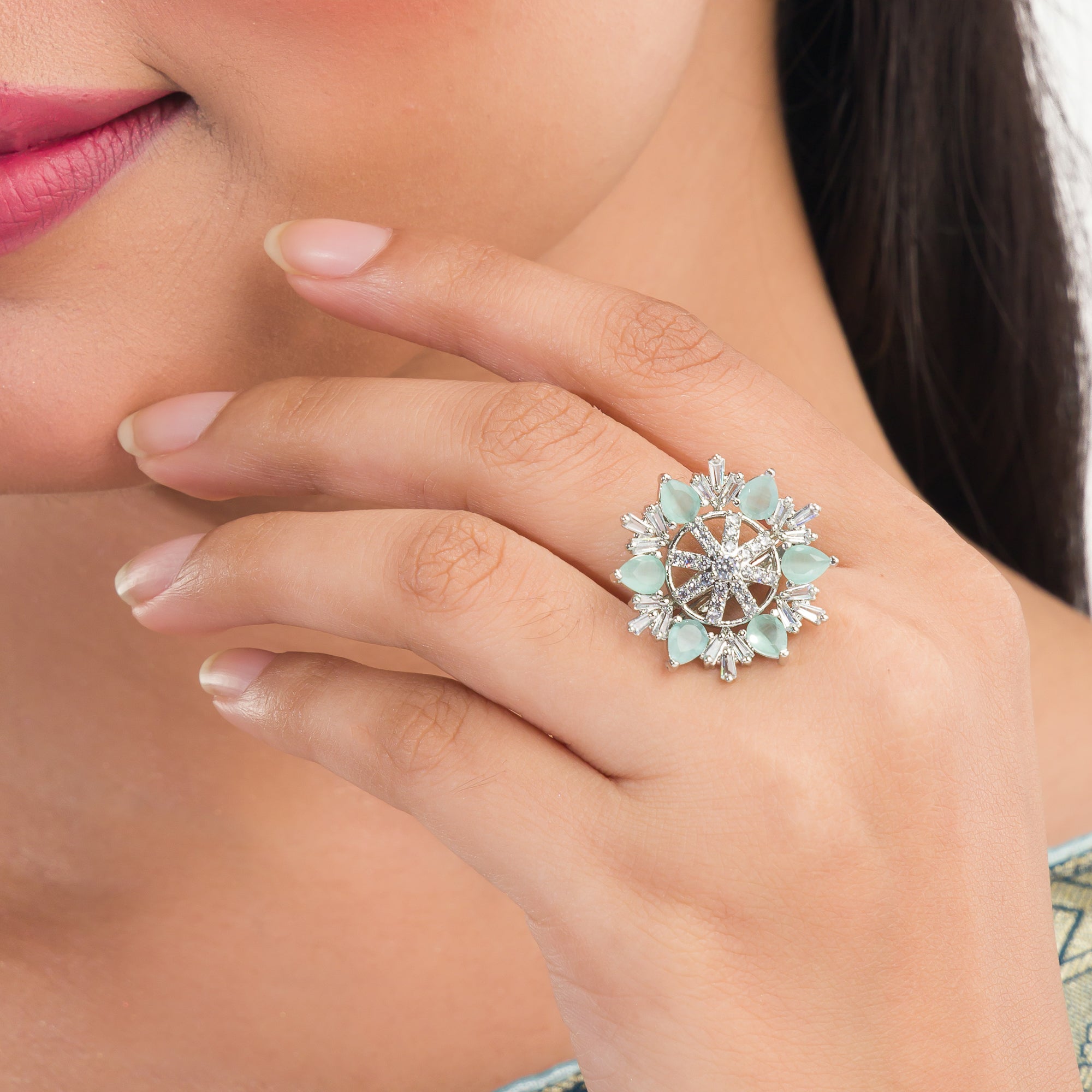 Aqua floral zircon finger ring adds a serene and vibrant charm to your party look.
