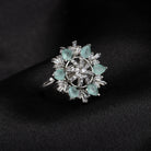 Aqua floral zircon finger ring adds a serene and vibrant charm to your party look.
