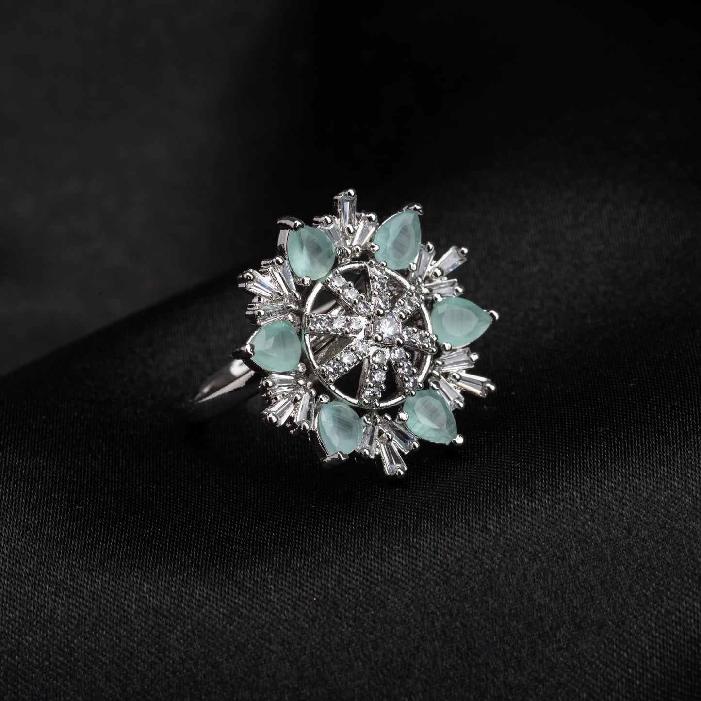 AQUA- COLOURED STONE STUDDED FLORAL DESIGN ZIRCON FINGER RING WITH AQUA- COLOURED STONE