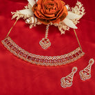 Red zircon bridal necklace set features intricate designs, perfect for a regal wedding look.
