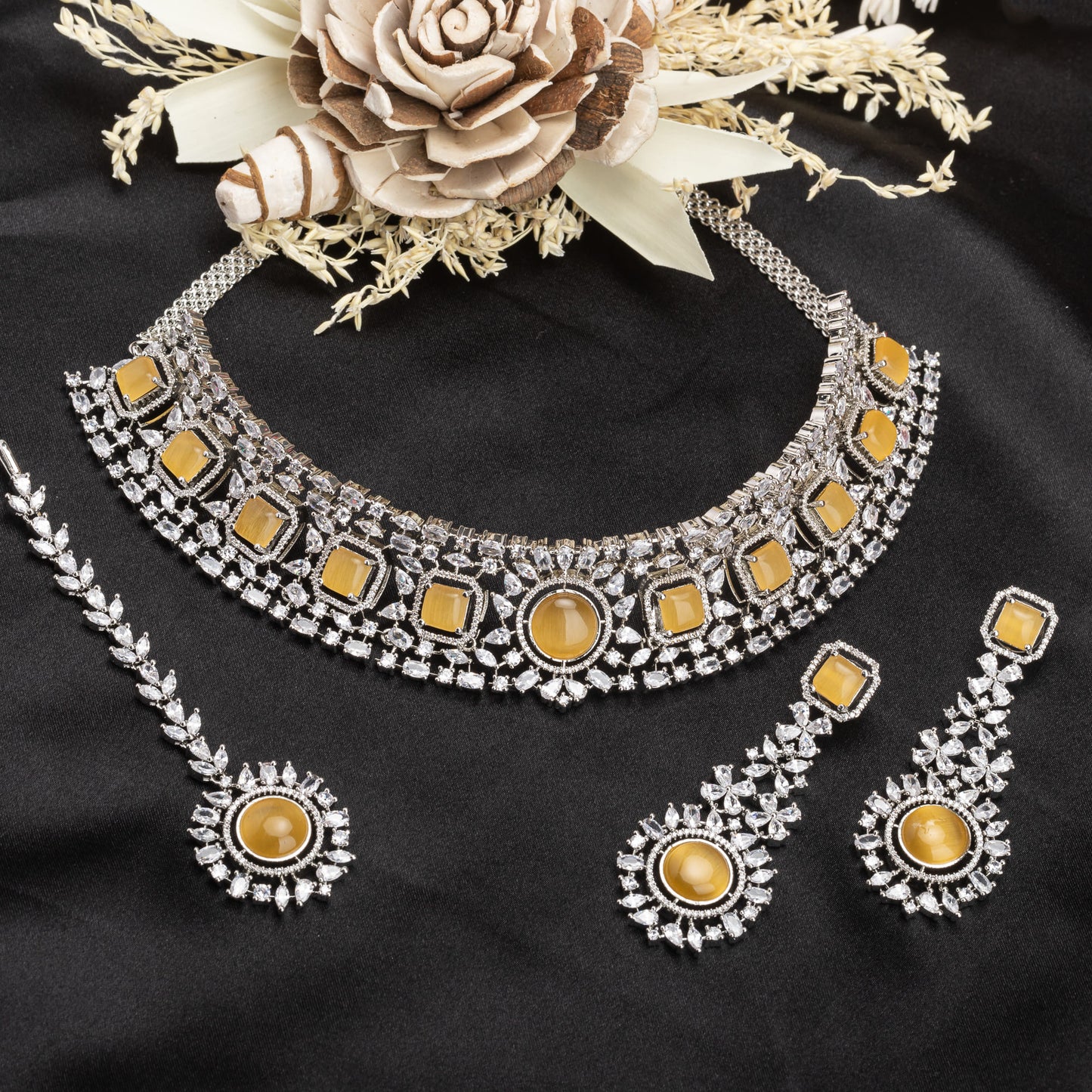 A WHITE ZIRCON-STUDDED NECKLACE SET FEATURES A NECKLACE AND MATCHING EARRINGS