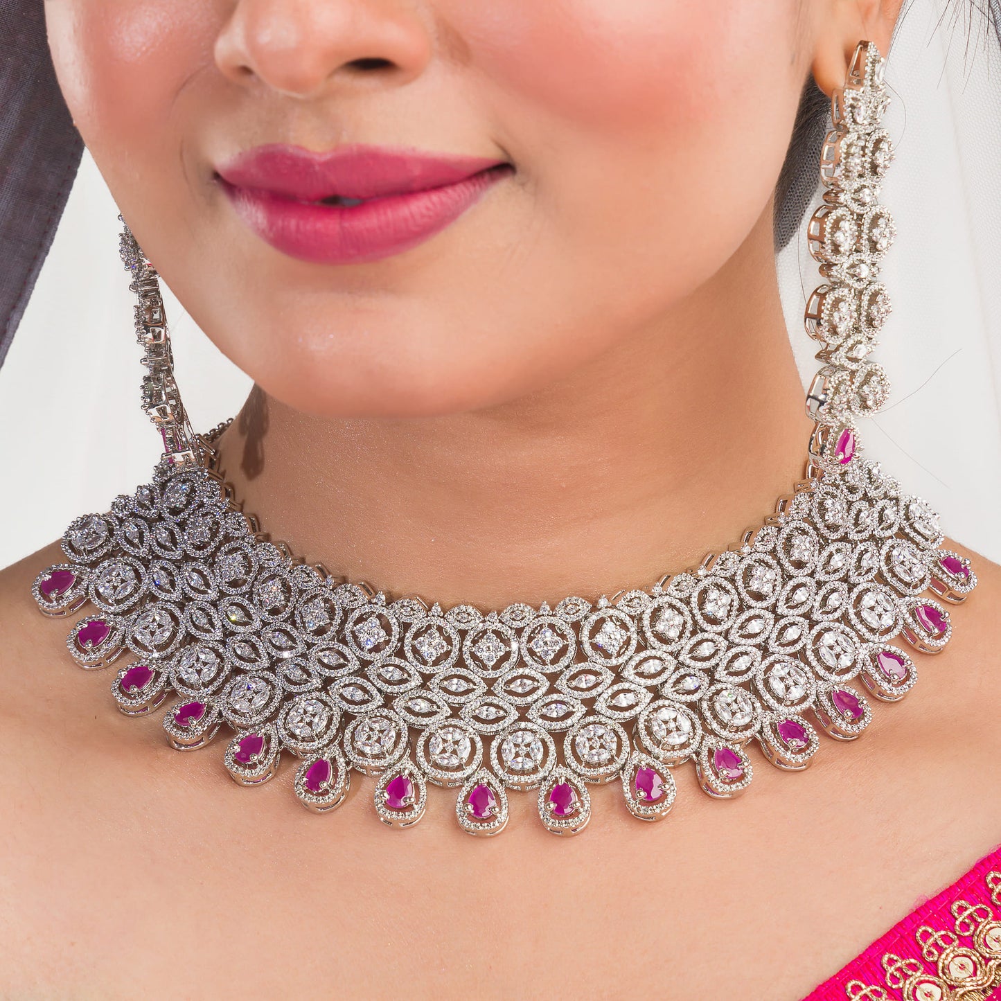 THIS STUNNING PINK COLOUR STONE-STUDDED ZIRCON BRIDAL SET FEATURES A DAZZLING NECKLACE ADORNED WITH INTRICATELY DESIGNED STONES