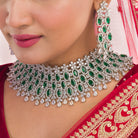 Green zircon bridal necklace set with intricate stone design for a regal look.
