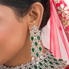 Green zircon bridal necklace set with intricate stone design for a regal look.
