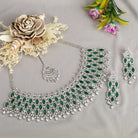 Green zircon bridal necklace set with intricate stone design for a regal look.
