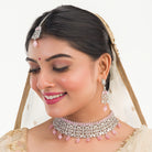 Pink pearl and white zircon bridal choker set with earrings and maangtika.
