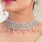 Pink pearl and white zircon bridal choker set with earrings and maangtika.
