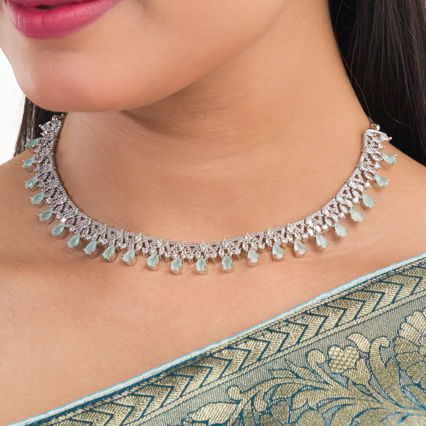 THIS EXQUISITE AQUA-COLORED STONE-STUDDED ZIRCON NECKLACE SET RADIATES ELEGANCE AND CHARM