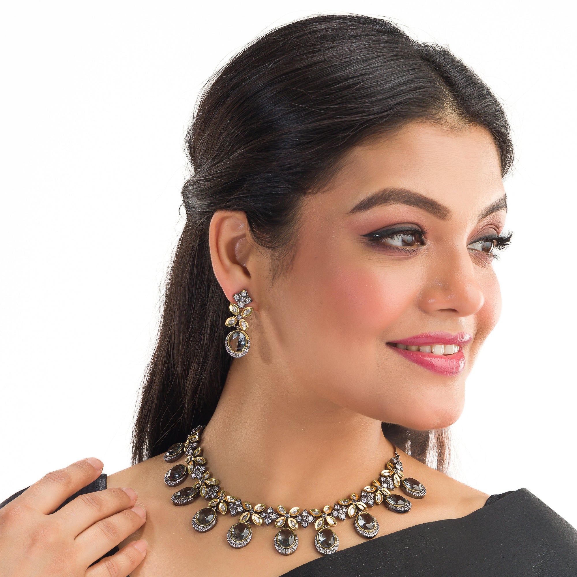 Black polished zircon necklace set with matching earrings for a sleek and stylish festive look.
