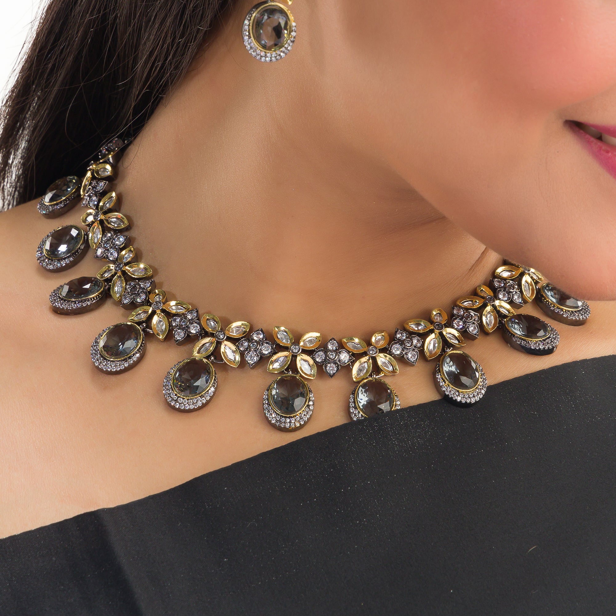 Black polished zircon necklace set with matching earrings for a sleek and stylish festive look.
