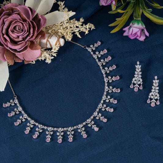 THIS NECKLACE SET FEATURES PINK AND WHITE ZIRCON STONES INTRICATELY SET TO CREATE A DELICATE AND ELEGANT DESIGN. PAIRED WITH MATCHING EARRINGS.