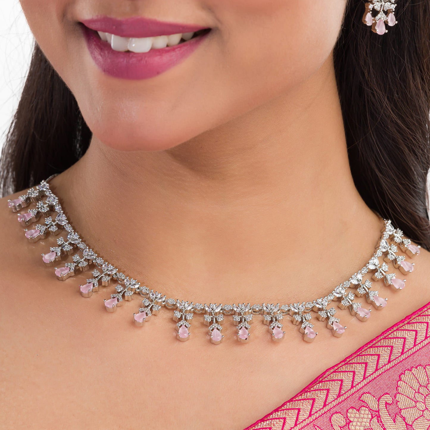 THIS NECKLACE SET FEATURES PINK AND WHITE ZIRCON STONES INTRICATELY SET TO CREATE A DELICATE AND ELEGANT DESIGN. PAIRED WITH MATCHING EARRINGS.