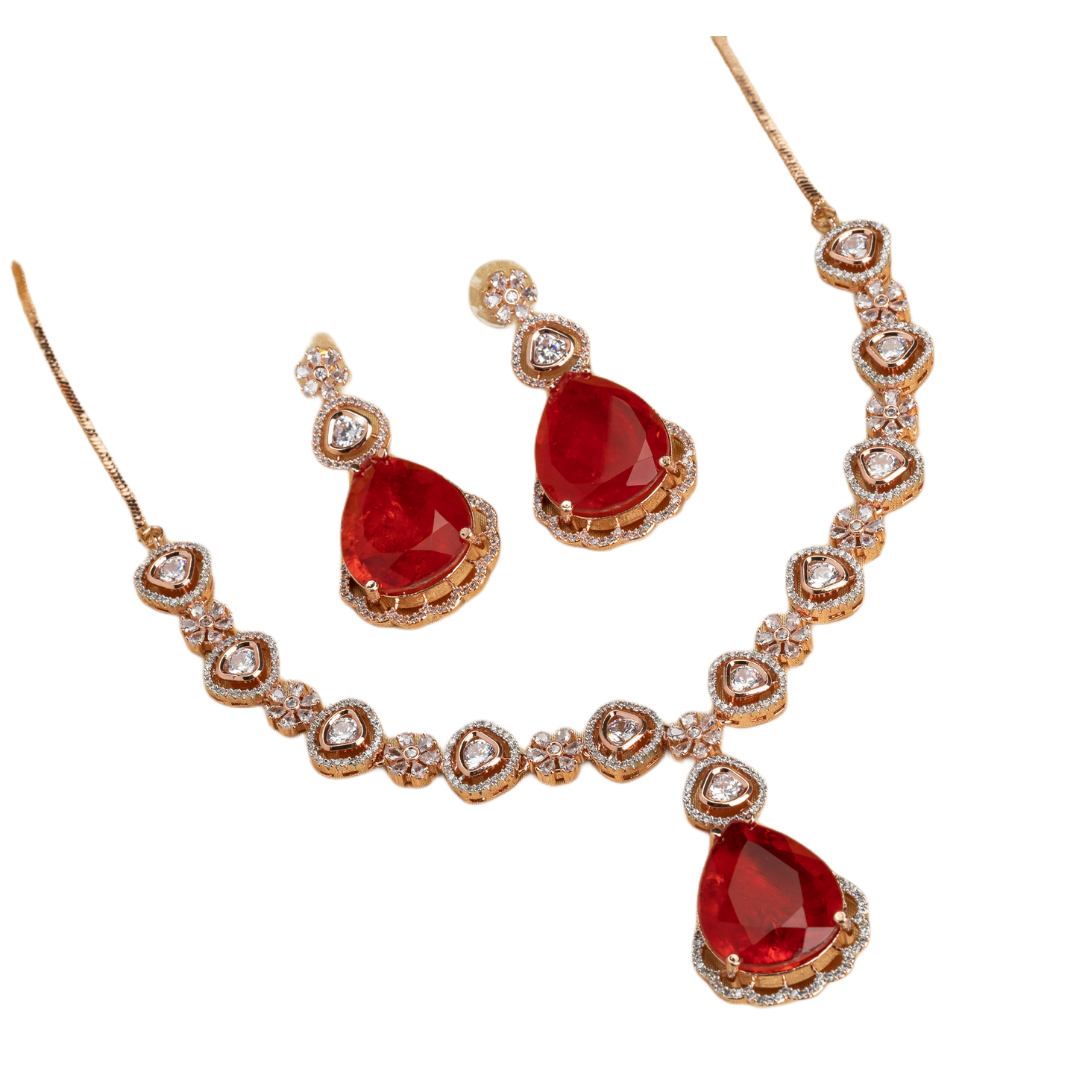 Rose gold necklace set with red stones and zircon accents for a bold and elegant party look.
