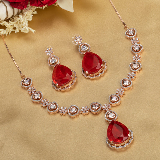 THIS ROSE GOLD POLISHED NECKLACE SET SHOWCASES A STRIKING PENDANT WITH LARGE RED STONES, BEAUTIFULLY ACCENTED BY ZIRCON STUDS.