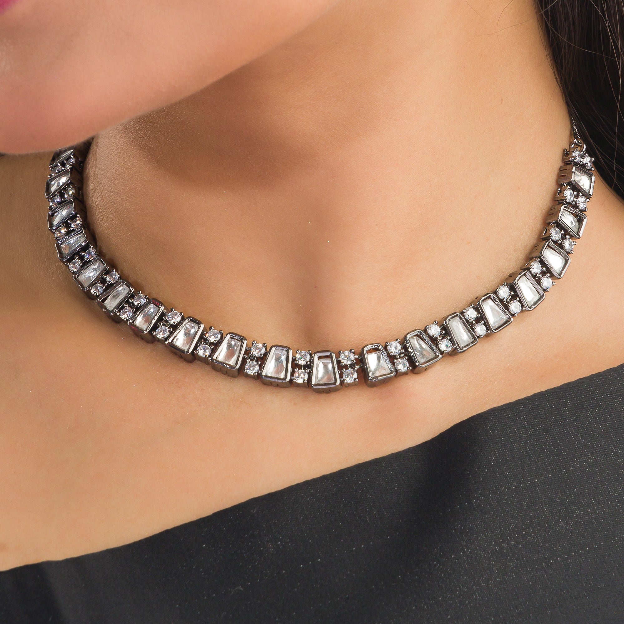 Black polished zircon necklace set with white stones for a sleek and striking design.
