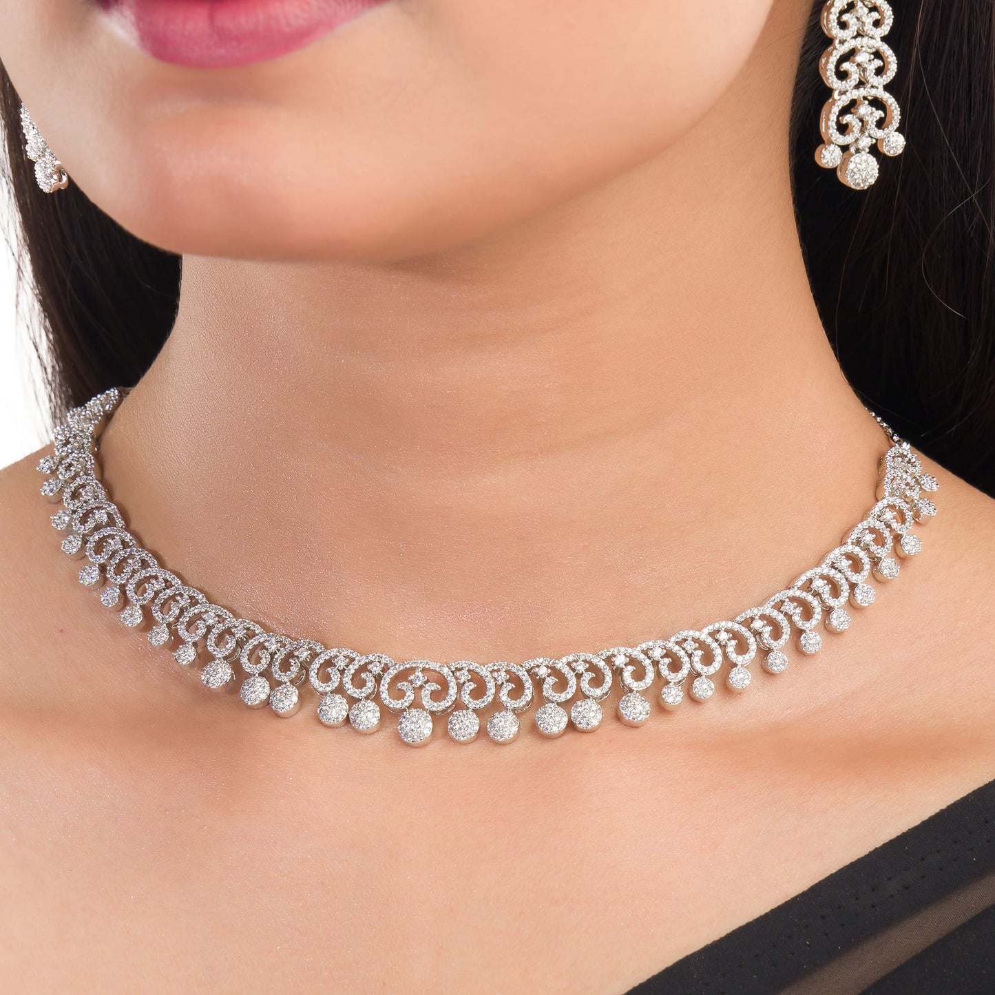 THIS WHITE ZIRCON STONE-STUDDED SHORT NECKLACE SET EXUDES TIMELESS ELEGANCE AND SOPHISTICATION. INCLUDES MATCHING EARRINGS,