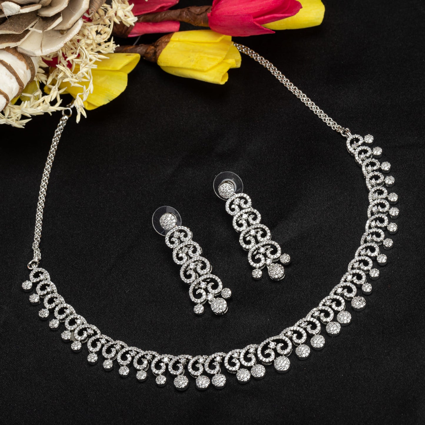 THIS WHITE ZIRCON STONE-STUDDED SHORT NECKLACE SET EXUDES TIMELESS ELEGANCE AND SOPHISTICATION. INCLUDES MATCHING EARRINGS,