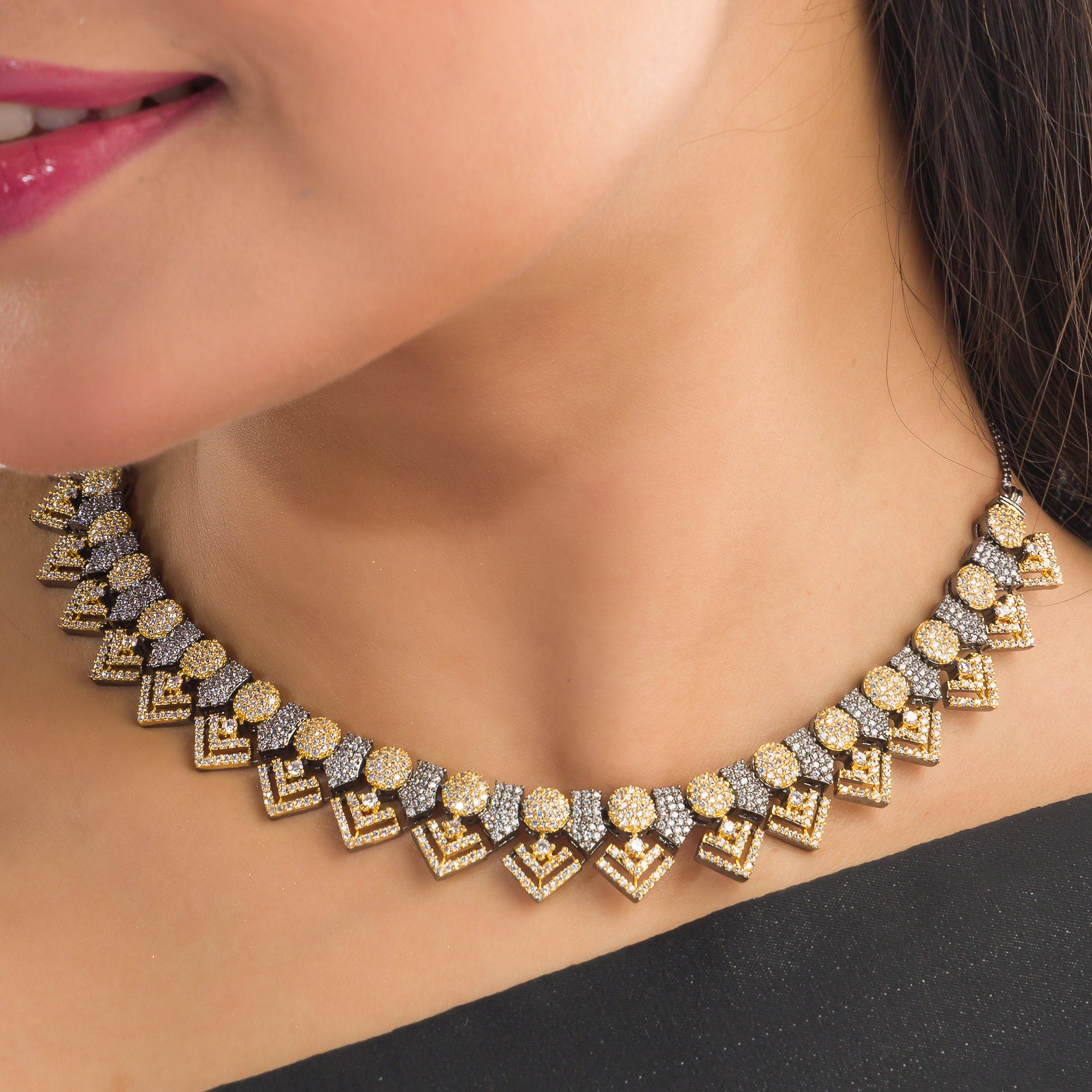 Black polished necklace set with golden and white zircon stones for an elegant and striking contrast.
