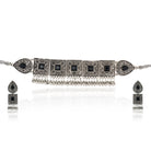 Oxidised choker set with black stones and matching earrings for a stunning festive appearance.
