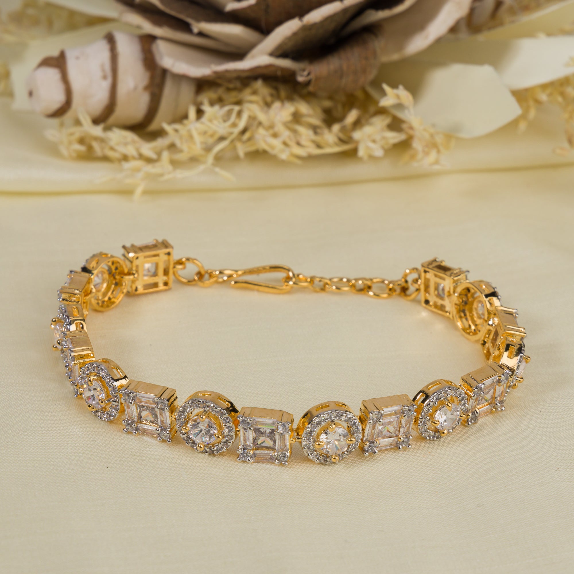 Golden zircon-studded bracelet with shimmering stones, perfect for an elegant party look.
