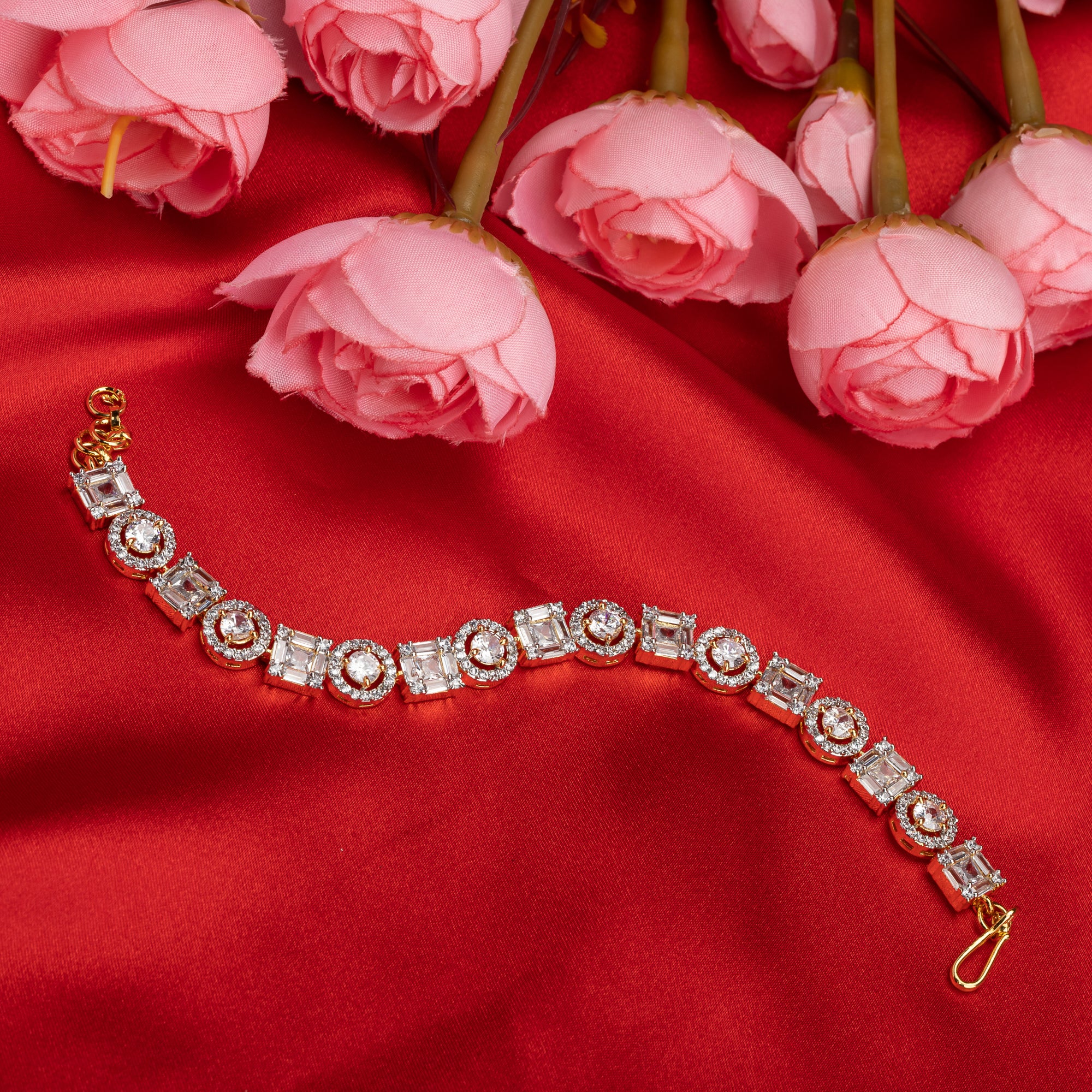 Golden zircon-studded bracelet with shimmering stones, perfect for an elegant party look.
