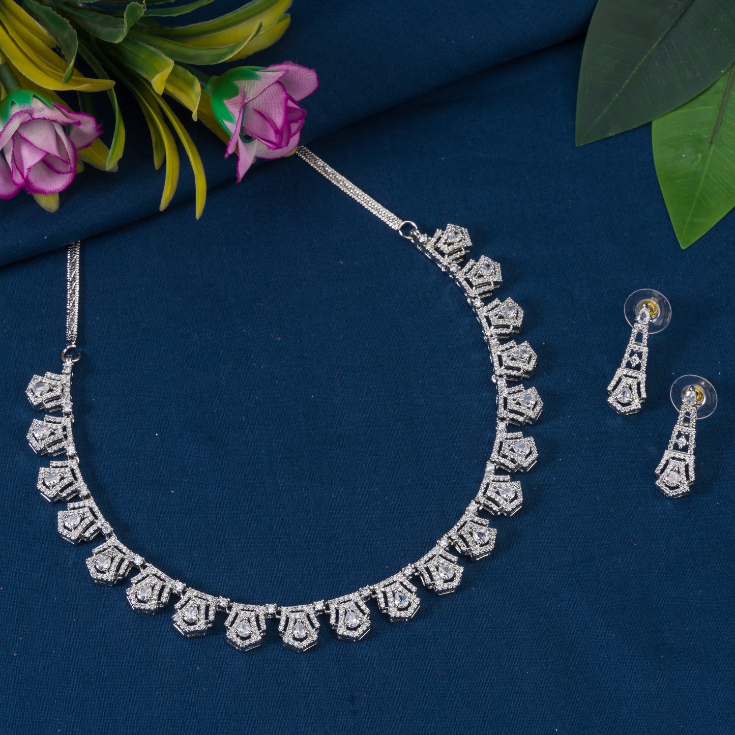 THIS WHITE ZIRCON STONE-STUDDED SHORT NECKLACE SET EXUDES TIMELESS ELEGANCE AND SOPHISTICATION. INCLUDES MATCHING EARRINGS,