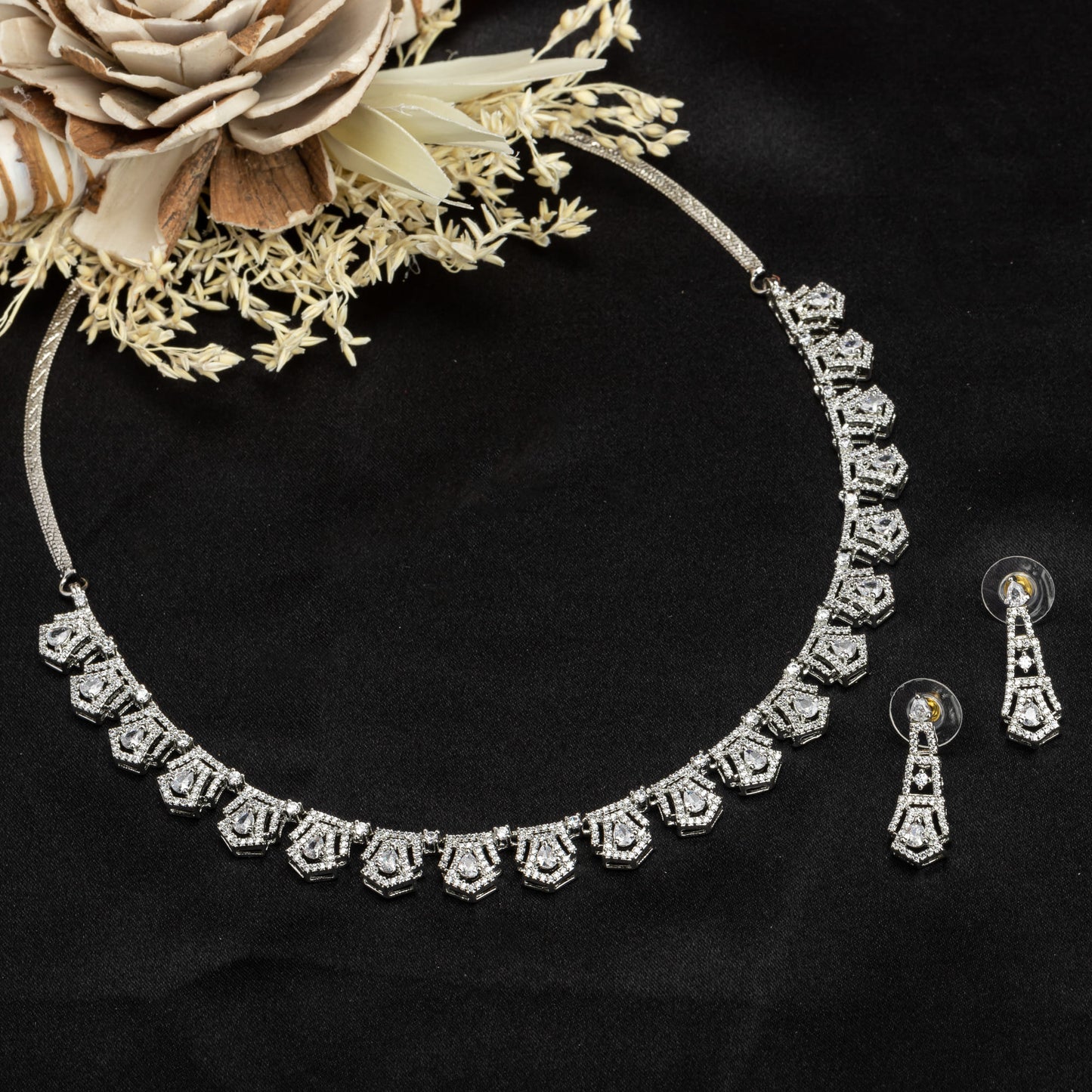 THIS WHITE ZIRCON STONE-STUDDED SHORT NECKLACE SET EXUDES TIMELESS ELEGANCE AND SOPHISTICATION. INCLUDES MATCHING EARRINGS,