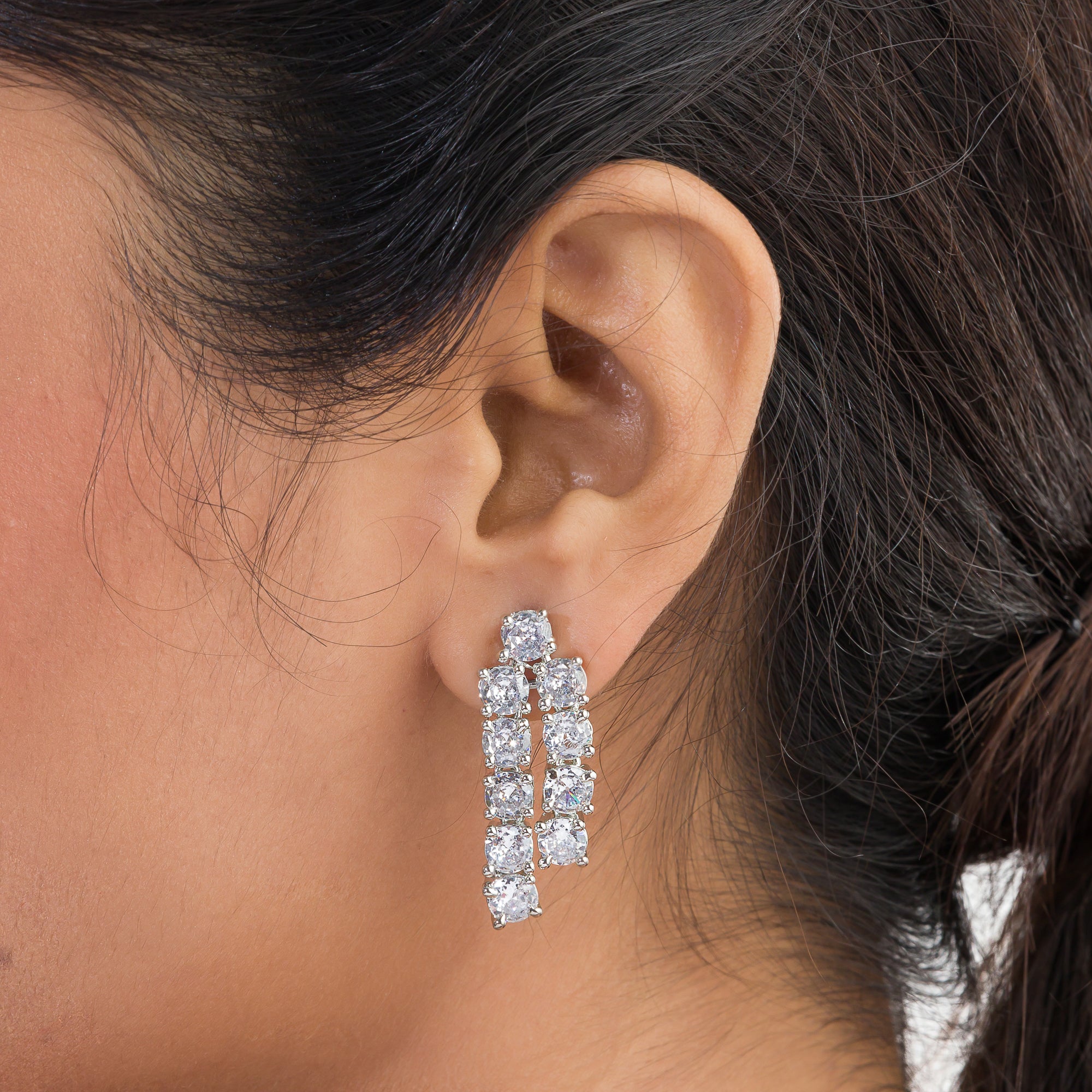 Double-layer silver necklace set with white zircon stones and matching earrings for sophistication.
