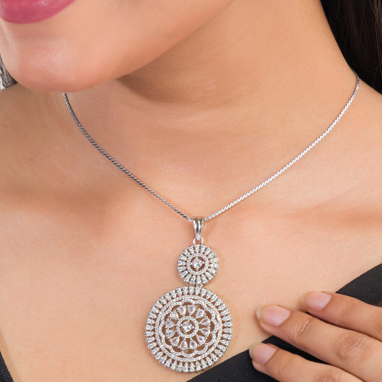 THIS PENDANT SET FEATURES FLORAL DESIGN ADORNED WITH WHITE ZIRCON STONES , PAIRED WITH MATCHING EARRINGS, .