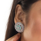 Floral zircon pendant set with turquoise and white stones, paired with matching earrings.
