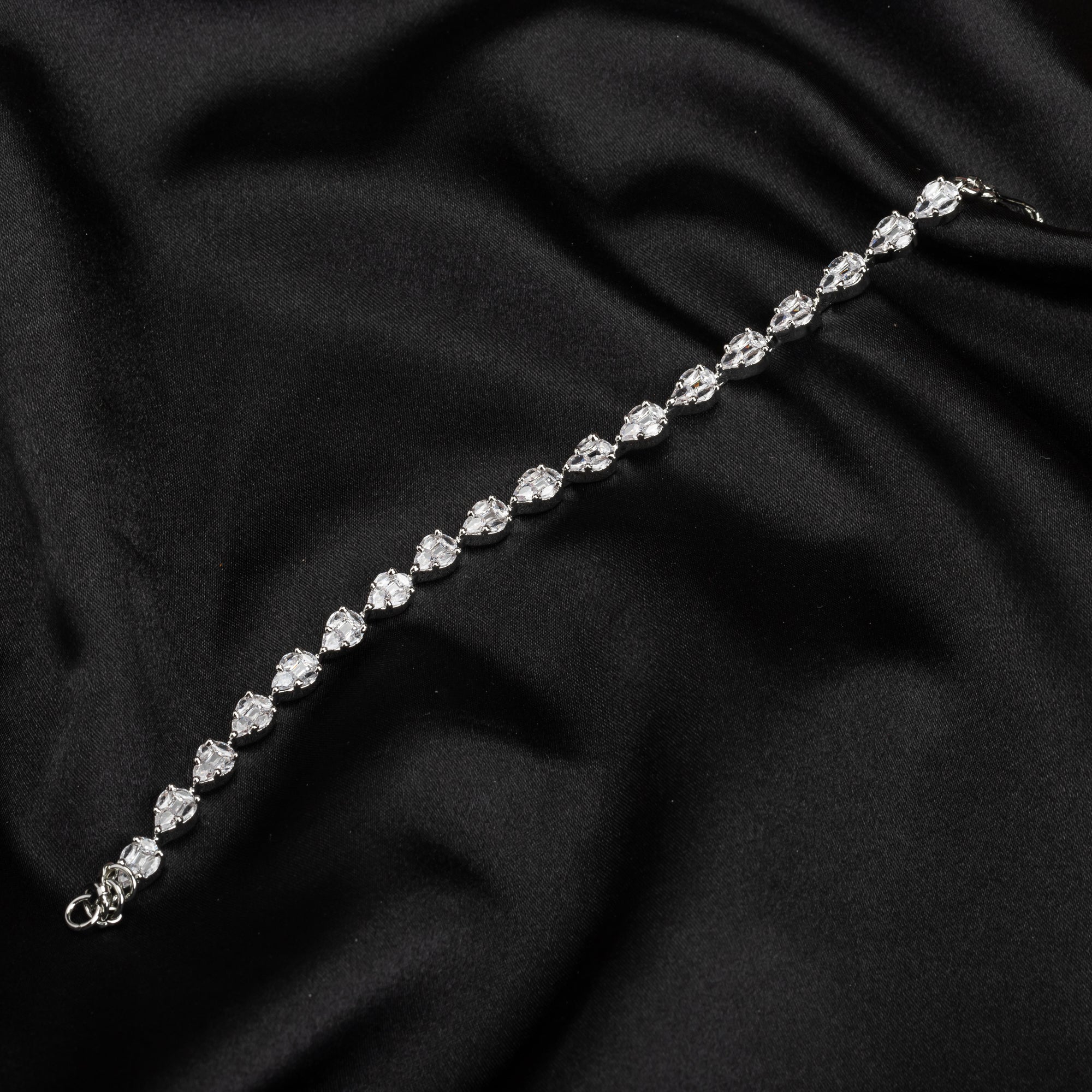 Silver zircon-studded chain bracelet, perfect for adding shimmer to your party wear.
