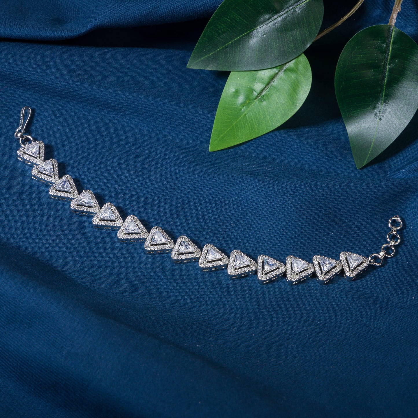 THIS SILVER-POLISHED CHAIN BRACELET, STUDDED WITH SHIMMERING ZIRCON STONES, IS PERFECT FOR PARTY WEAR.