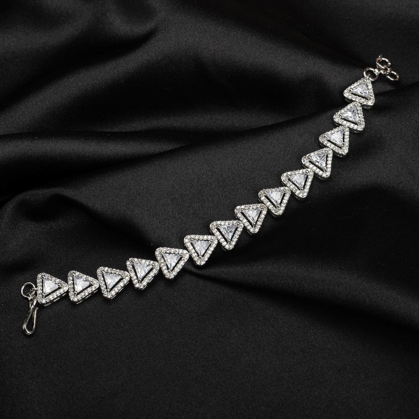 THIS SILVER-POLISHED CHAIN BRACELET, STUDDED WITH SHIMMERING ZIRCON STONES, IS PERFECT FOR PARTY WEAR.