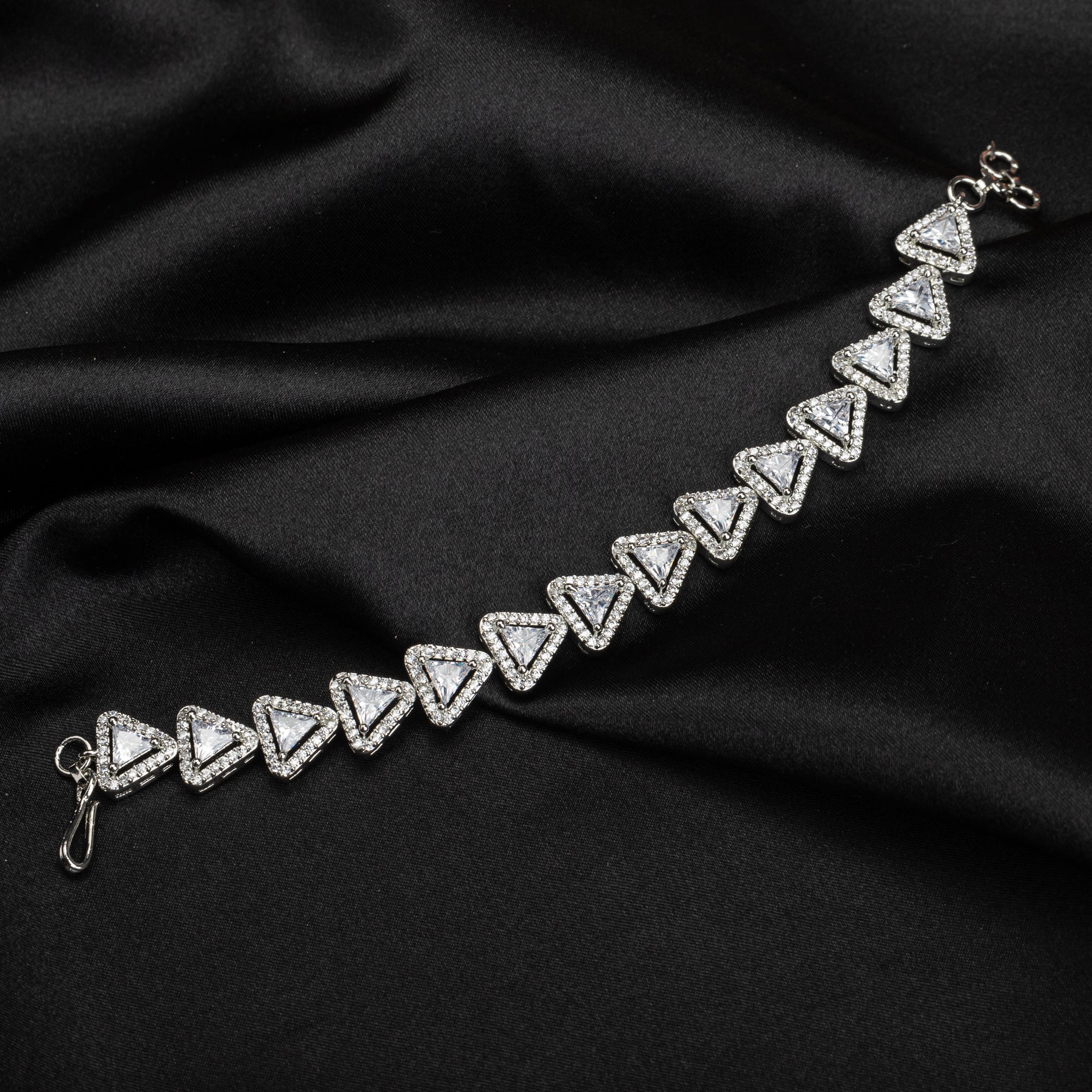 Silver zircon-studded chain bracelet adds sparkle and elegance to your party outfit.
