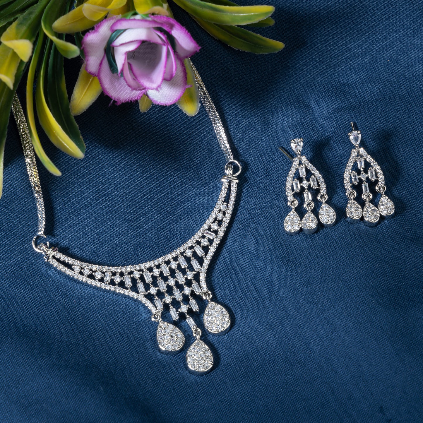 THIS WHITE ZIRCON-STUDDED PENDANT AND EARRINGS SET. PERFECT FOR ADDING ELEGANCE TO ANY ENSEMBLE.