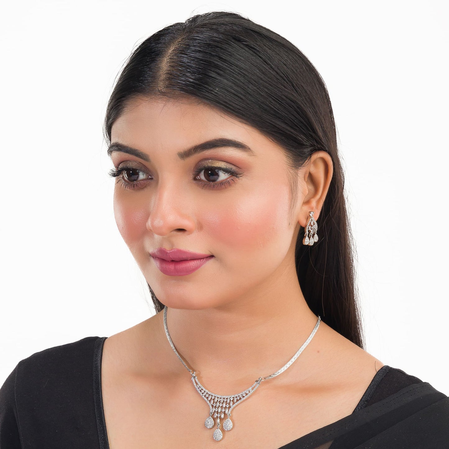 THIS WHITE ZIRCON-STUDDED PENDANT AND EARRINGS SET. PERFECT FOR ADDING ELEGANCE TO ANY ENSEMBLE.