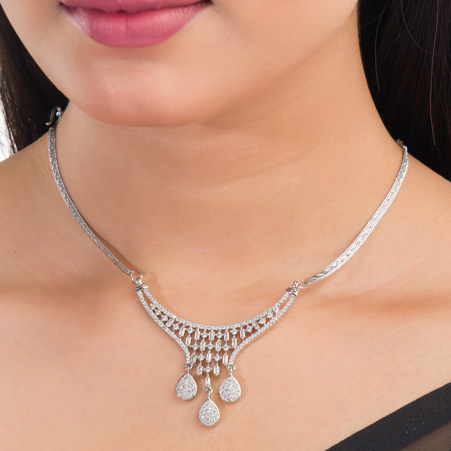 THIS WHITE ZIRCON-STUDDED PENDANT AND EARRINGS SET. PERFECT FOR ADDING ELEGANCE TO ANY ENSEMBLE.