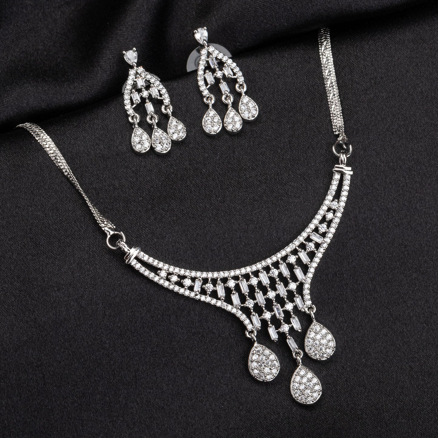 THIS WHITE ZIRCON-STUDDED PENDANT AND EARRINGS SET. PERFECT FOR ADDING ELEGANCE TO ANY ENSEMBLE.