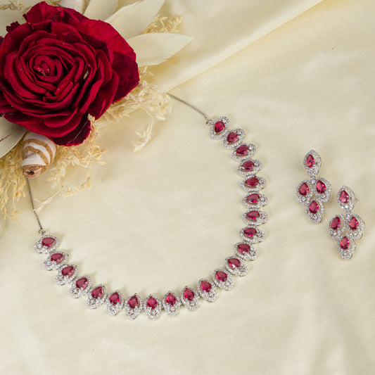 MAKE A BOLD STATEMENT WITH THIS RED STONE-STUDDED ZIRCON NECKLACE SET. ITS VIBRANT STONES AND SPARKLING ZIRCONS CREATE A STRIKING AND ELEGANT LOOK.